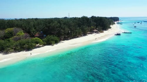 Aerial drone shot nature of idyllic tourist beach vacation by blue green lagoon and white sandy back