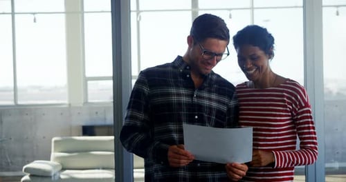 Executives having discussion over document in office