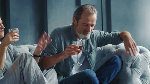 Mature Couple Toasting with Wine at Home