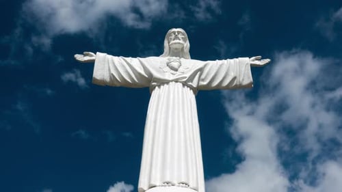 Religious Statue with Open Arms and Blue Sky