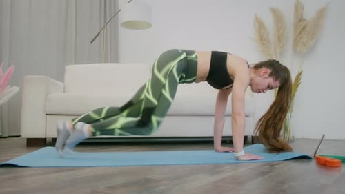 Woman Doing Mountain Climbers on a Yoga Mat
