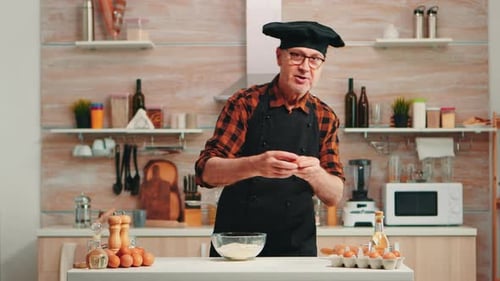 Chef Cracks Eggs Into Bowl in Bright Kitchen