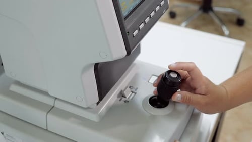 Close Up of Woman Doctor Working with the Refractometer Machine