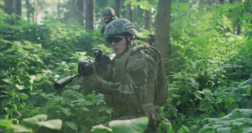 Soldiers Holding Rifles Ambushed in Dense Fores During Day Time Protecting Base with Full Tactical