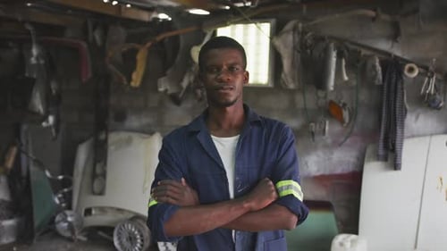 Adult Standing with Arms Crossed in Auto Repair Shop
