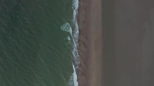 Generic Brown Beach Pattern and Dark Green Ocean on Cloudy Day, Top Down Overhead Aerial Birds Eye