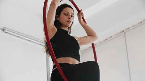 Woman Performing Aerial Hoop Gymnastics in Studio