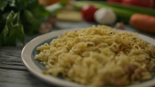 Plate of Cooked Noodles With Fresh Vegetables