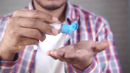 Man applying hand sanitizer for health and hygiene