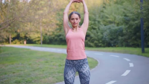 Woman Runner Stretching Arms Before Running Summer Park