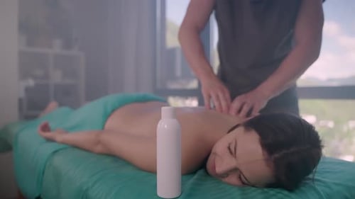 Relaxation for Body and Mind in Spa Salon Woman is Enjoying Massage