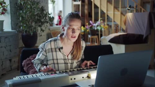Woman Playing Keyboard in Home