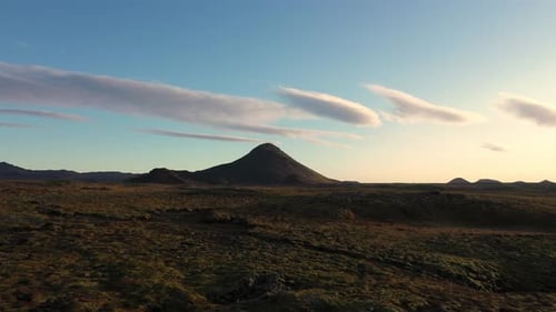 Drone Over Sparse Landscape To Mountain