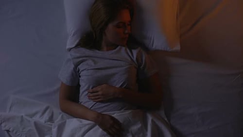 Distressed Woman Struggling with Insomnia at Night