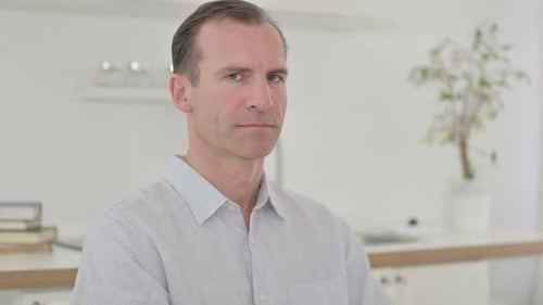 Man Giving Thumbs Up Gesture Indoors