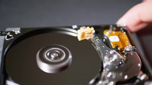 Festplattenlaufwerk mit rotierender Platte geöffnet. Bewegung des Magnetkopfs. Zeitlupe