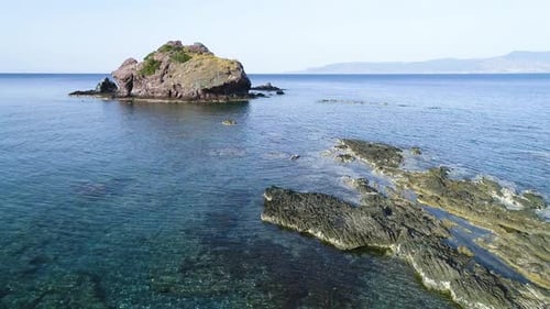 Aerial Top View of Cliff Rocks in a Blue Ocean