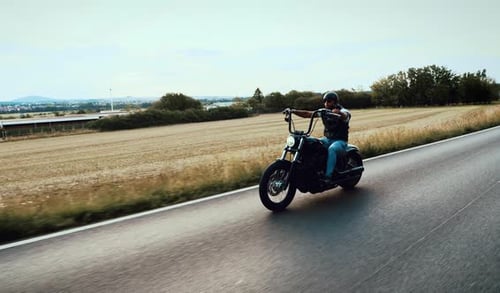 Man Riding Motorcycle on Country Road
