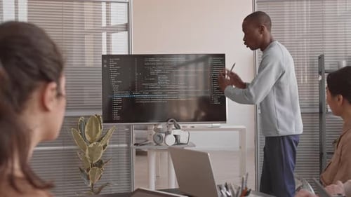 Man Explaining Code During a Corporate Presentation
