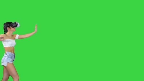 Woman Using VR Virtual Reality Headset Walking and Dancing on a Green Screen, Chroma Key