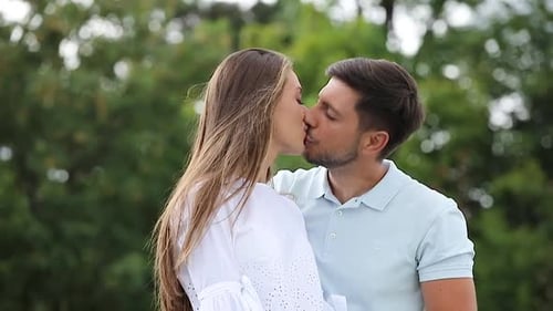 Affectionate Couple Sharing a Tender Kiss Outdoors