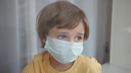 Child wearing protective medical mask