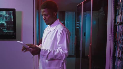Portrait of Black Male IT Specialist in Data Center