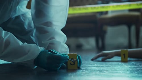 Crime Scene Investigator Gathers Bullet Casing Evidence