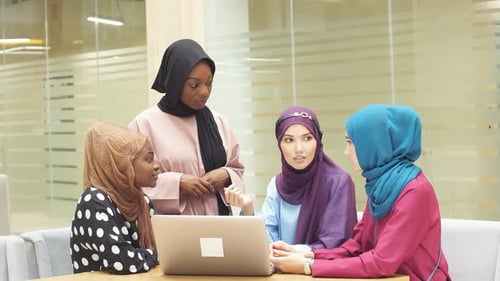 Women with Headscarves Working on Laptop in Office
