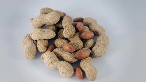 Pile of Delicious Peanuts on a White Surface
