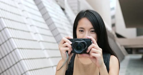 Young Woman Taking Pictures in the City