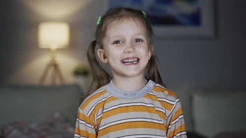 Happy Little Girl Smiling and Talking Indoors