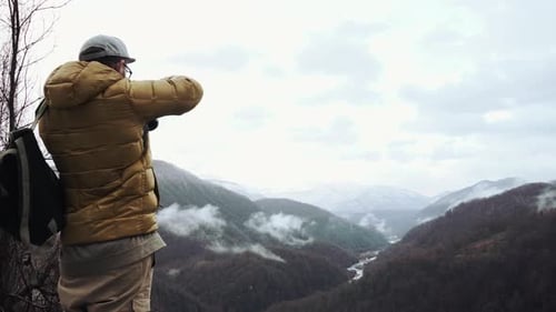 Photographer Is Taking Pictures of Dramatic River Valley, Stand on a Hilltop