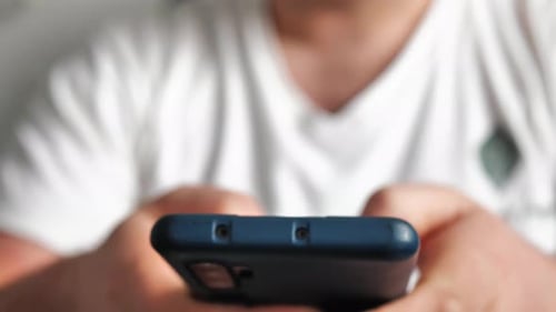 Young Man Look at Cellphone and Browse Social Network Close Up