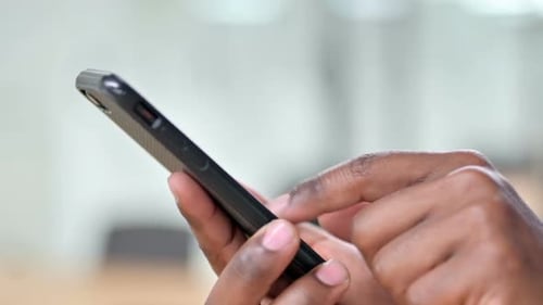 Close Up of African Man Using Smartphone