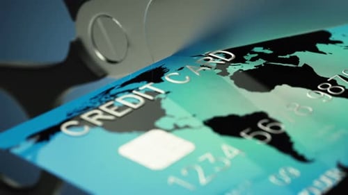 Zoom out animation of a credit card being cut by a pair of scissors. HD