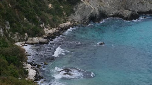 Coast with Crystal Clear Turquoise Sea Waves Breaking on the Rocks and Cliffs