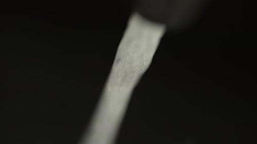 Stream of Water Flowing on a Black Background