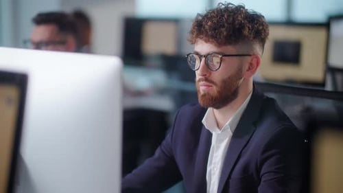 Portrait of Young Entrepreneur in Open Space Office Working on Decktop Computer