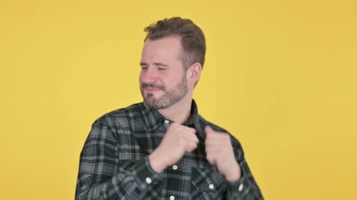 Man Dances Energetically on Yellow Background