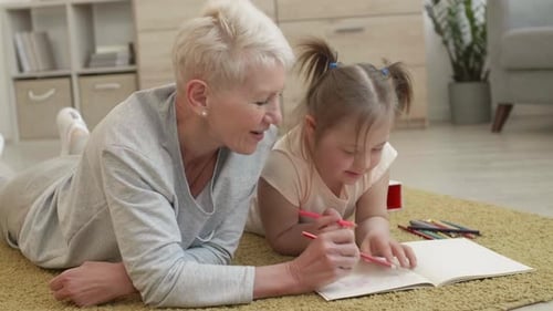 Child and Adult Draw Together at Home