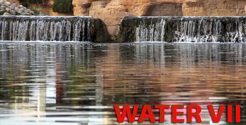 Water Cascading Off Stone Structure Into Pond