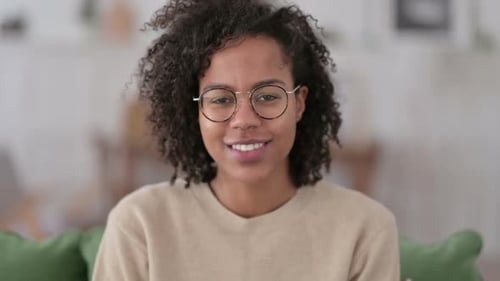 Young Woman Smiling and Looking at Camera