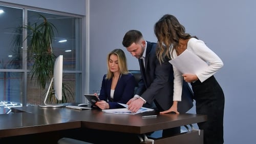 Business Team Discussing Charts in Modern Office