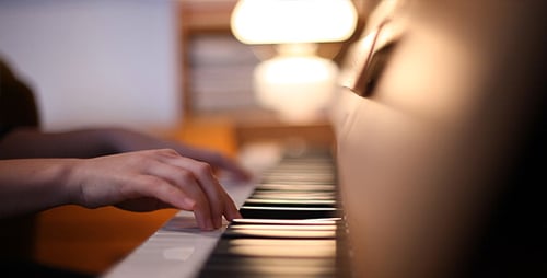 Hands Playing Piano Keyboard Indoors