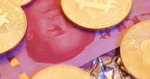 Golden Bitcoin Coins on Chinese Yuan Currency