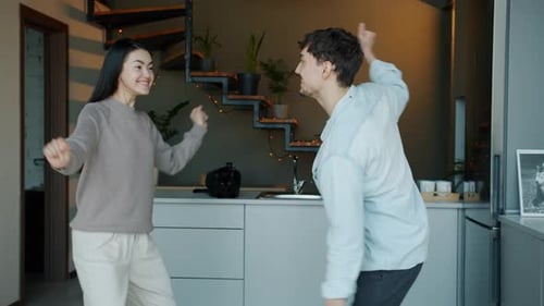 Happy Couple Dancing in Modern Kitchen at Home