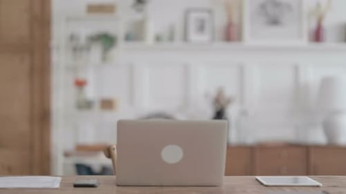 African Man Coming Back Opening Laptop in Office