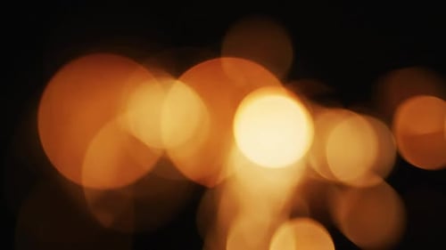 Abstract Golden Light Bokeh Against Dark Background
