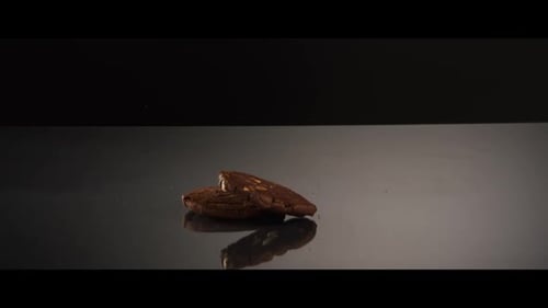 Falling cookies from above onto a reflective surface - COOKIES